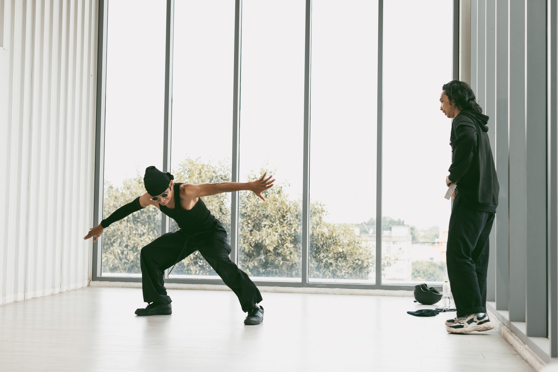Breakdancer training with coach in dance studio.