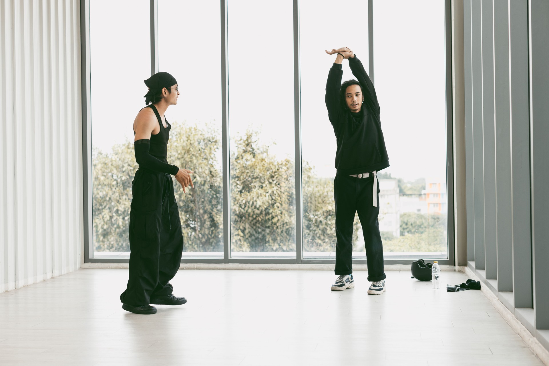 Breakdancer training with coach in dance studio.